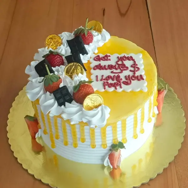 Passion Fruit Cake in Meru decorated with strawberries, cream frosting and chocolate toppings