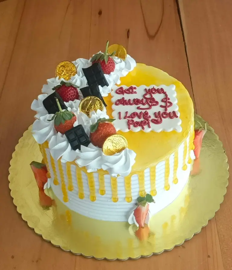 Passion Fruit Cake in Meru decorated with strawberries, cream frosting and chocolate toppings